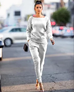 Detail showing the ribbed texture of the white knit long-sleeve top and matching pants