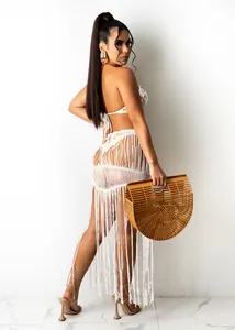 Detail view of a sexy white crochet knit two-piece set with fringe beach skirt for women