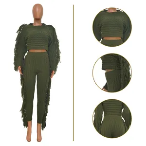 Detailed view of a green cable knit two-piece set with stylish fringe accents and textures