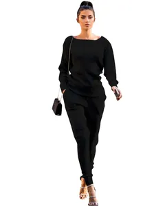 Model wearing a chic black ribbed long-sleeve top and matching jogger pants set