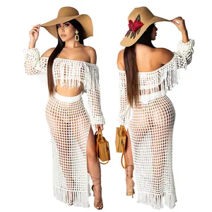 Two-piece white crochet beach set featuring a fringe top and an elegant mesh maxi skirt