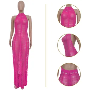 Detail view of pink knitted beach maxi dress with halter neck and hollow-out design