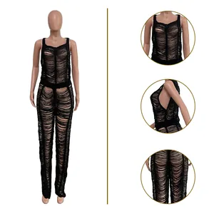 Detailed macro view of the sexy black knitted hollow-out jumpsuit for beachwear.