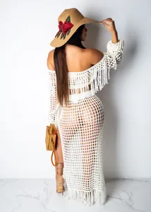 Back view of women's white crochet mesh beach skirt set with tassel details