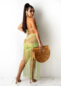 Detailed view of lime green knit fringe beach skirt two-piece set on model