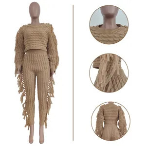 Close-up detail of cable knit texture and long fringe accents on brown two-piece set
