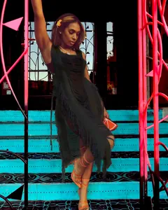 Detail showing black fringe beach dress with a stylish and elegant side-tie design.