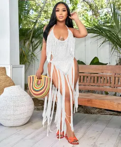 Stunning macro view of white crochet one-piece swimsuit with elegant long cascading fringe