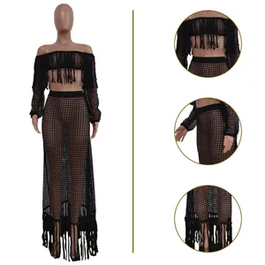 Details of black mesh beach set featuring fringe tassels and long-sleeved crop top
