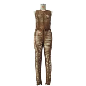 Close-up detail of sexy brown knitted hollow-out jumpsuit with tassel texture for beachwear