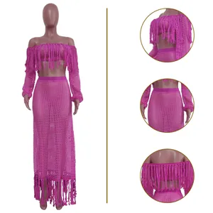 Detailed view of fuchsia mesh crochet two-piece beach set featuring fringe accents