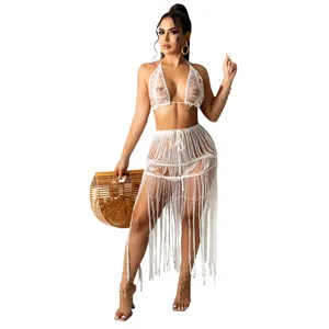 White knit mesh two-piece beachwear set with tassel fringe skirt and halter top set.