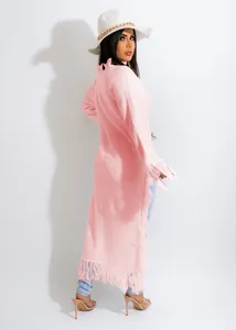 Detailed back view of a long pink knitted cardigan with elegant fringe hem design