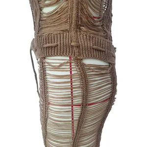 Close-up detail of brown knitted hollow-out texture on sexy beach one-piece outfit