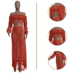 Close-up detail of the orange crochet mesh beachwear two-piece set with tassel fringes