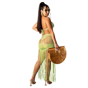 Full back view of a sexy lime green knitted crochet fringe beach skirt set on model