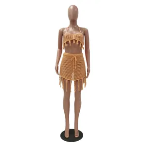 Detailed look at an apricot crochet mesh bikini two-piece beachwear set with tassels