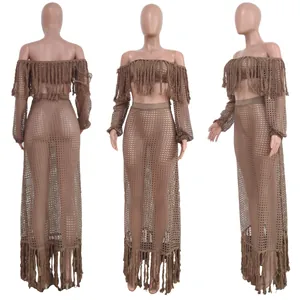 Close-up detail of a two-piece mesh beach set with tassels shown on a mannequin.