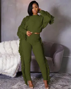 Detail of olive green knitted two-piece set featuring stylish long fringe and waffle texture.