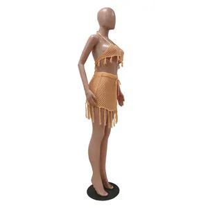 Close-up detail of crochet mesh two-piece beachwear set featuring decorative fringe