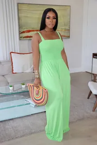 Elegant lime green sleeveless smocked bodice wide-leg jumpsuit shown on a model