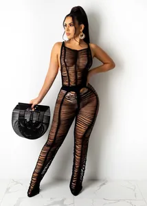 Detail of sexy black crochet knit sheer jumpsuit with distressed texture for beachwear