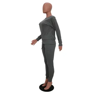 Side profile of a grey two-piece tracksuit set with long sleeves and jogger pants.