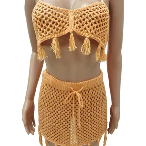 Detail view of an orange crochet mesh two-piece beach set with tassels and drawstring.