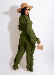 Elegant dark green two-piece knitted set featuring long sleeves with stylish fringe details