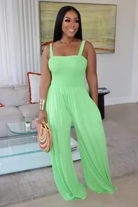 Stunning full-body view of a lime green wide-leg jumpsuit with smocked bodice detail