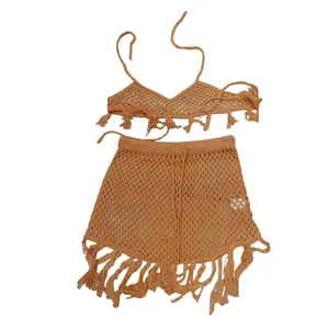 Detail macro view of the ochre crochet mesh bikini and fringe skirt beachwear set