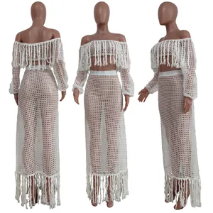 Three-angle view of white crochet mesh two-piece beach set with long tassel details