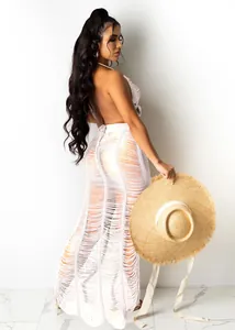 Detailed side view showing white crochet texture and backless design of beach maxi dress