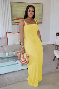 Full view of elegant yellow sleeveless wide-leg jumpsuit with a smocked bodice and straps.