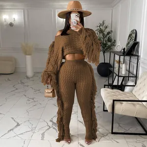 Detailed view of camel cable knit two-piece set featuring long fringe sleeves and pants.