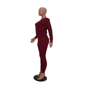Side view of a burgundy women's casual two-piece sweatshirt and joggers set.