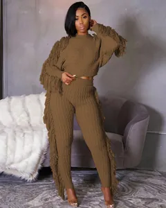 Detailed view of brown knit two-piece set featuring long fringe sleeves and pants