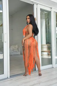 Detailed shot of orange knit fringe bodysuit with long swaying tassel accents