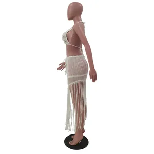 Detailed side view of a white knitted mesh fringe two-piece sexy beach skirt set