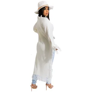 Back view of elegant white long fringe knit cardigan with bohemian tassel details for women