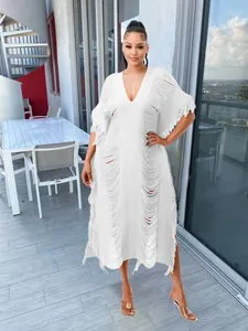 White hand-knitted tassel maxi dress with distressed hollow details for beachwear.