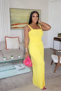 Full-length view of an elegant yellow smocked wide-leg jumpsuit for summer fashion