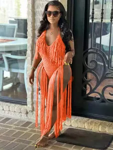 Detailed view of neon orange crochet bodysuit with long dramatic fringe