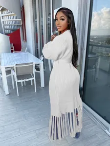 Elegant long white knitted cardigan with a tassel fringe hem and waist belt detail