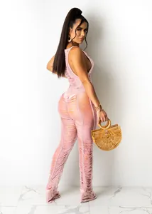 Macro view of the intricate pink knit texture on a sexy hollow out beach jumpsuit
