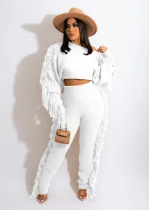 White knitted two-piece set featuring long sleeves and decorative fringe details