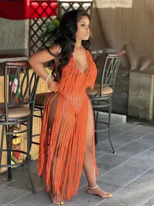Full body view of an orange knit swimsuit featuring long dramatic fringes and hollow design.