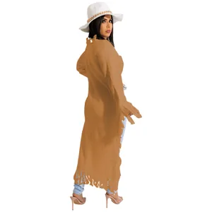 Detail view of long caramel knit cardigan with fringe hem and distressed collar