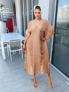 Full view of tan handmade knit kaftan dress with long horizontal fringe details.