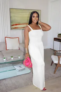 Solid white sleeveless wide-leg jumpsuit featuring a textured smocked bodice design